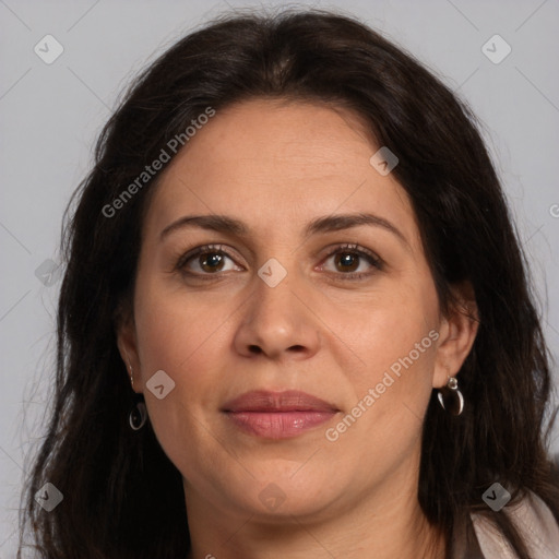 Joyful white adult female with long  brown hair and brown eyes