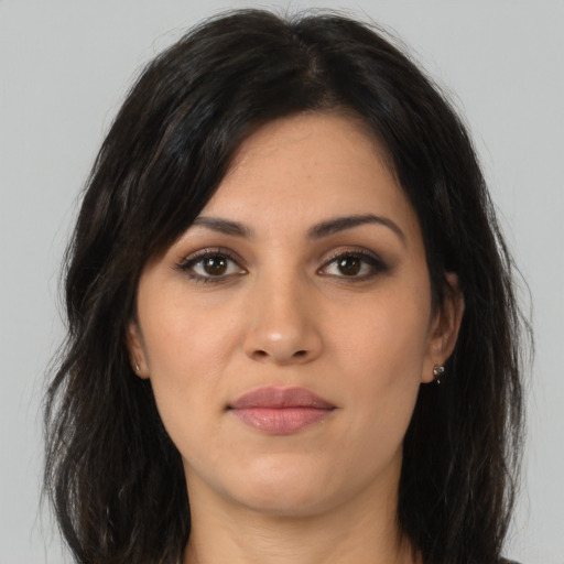Joyful latino young-adult female with long  brown hair and brown eyes