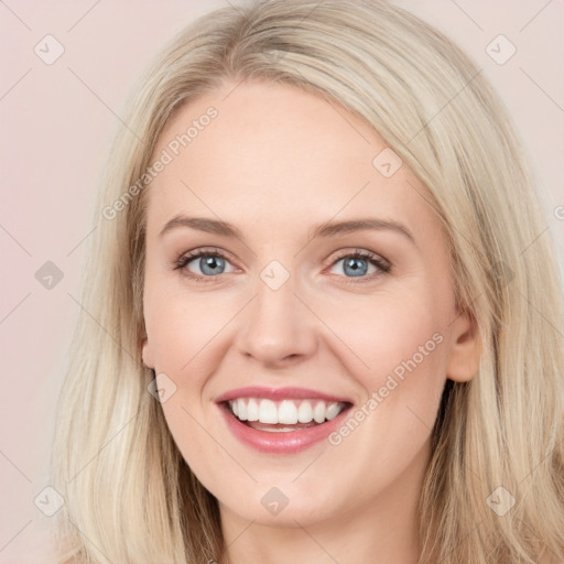 Joyful white young-adult female with long  brown hair and blue eyes