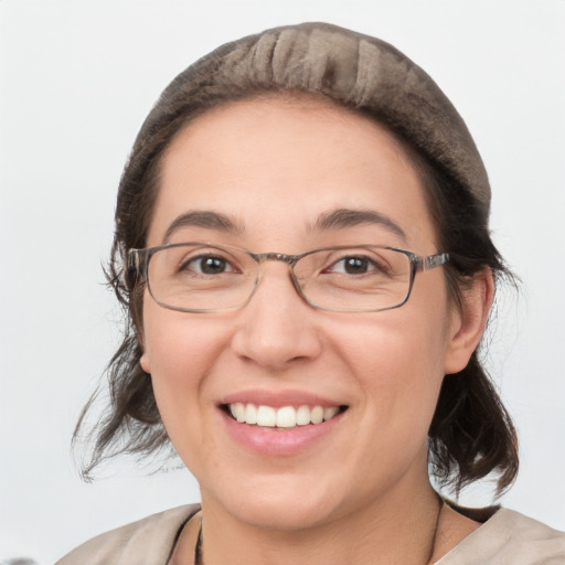 Joyful white adult female with medium  brown hair and green eyes