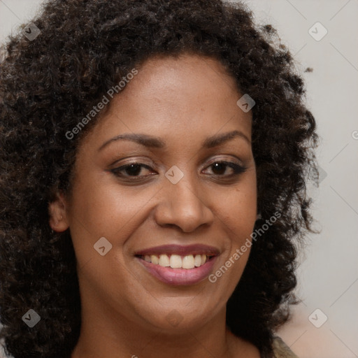 Joyful black young-adult female with long  brown hair and brown eyes