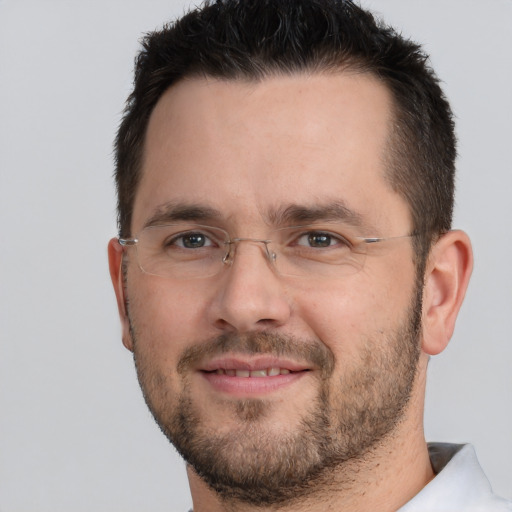 Joyful white adult male with short  brown hair and brown eyes