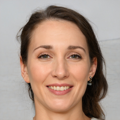 Joyful white adult female with medium  brown hair and brown eyes