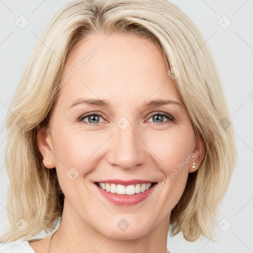 Joyful white young-adult female with medium  brown hair and blue eyes