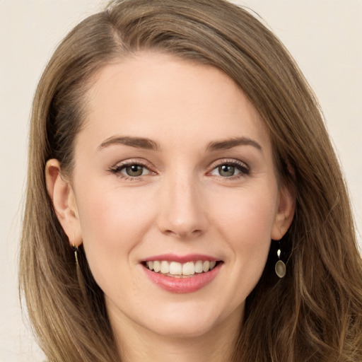 Joyful white young-adult female with long  brown hair and green eyes