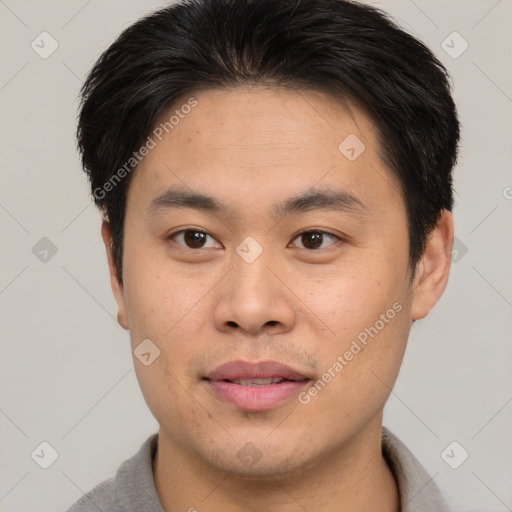 Joyful asian young-adult male with short  brown hair and brown eyes