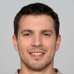 Joyful white young-adult male with short  brown hair and brown eyes