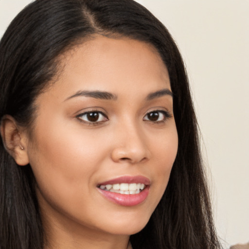 Joyful latino young-adult female with long  brown hair and brown eyes