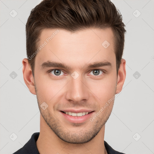 Joyful white young-adult male with short  brown hair and grey eyes