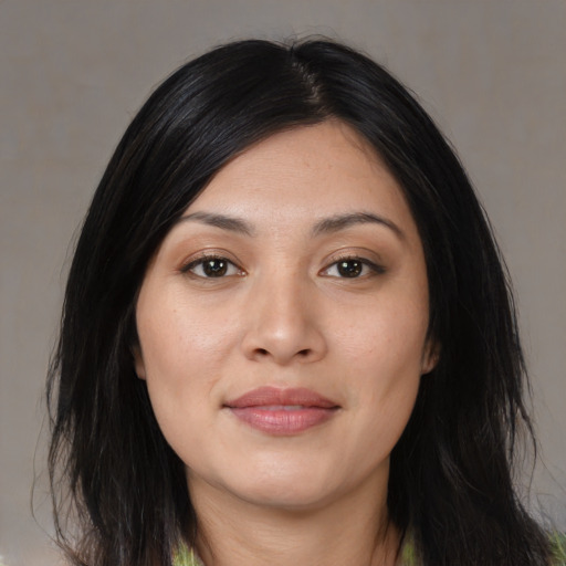 Joyful asian young-adult female with long  black hair and brown eyes