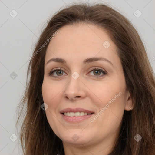 Joyful white adult female with long  brown hair and brown eyes