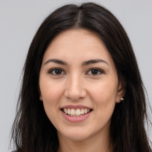 Joyful white young-adult female with long  brown hair and brown eyes