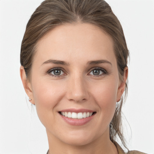 Joyful white young-adult female with medium  brown hair and grey eyes