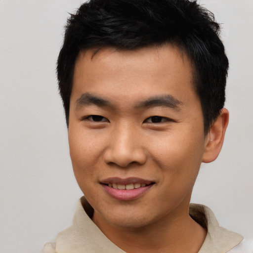 Joyful asian young-adult male with short  black hair and brown eyes
