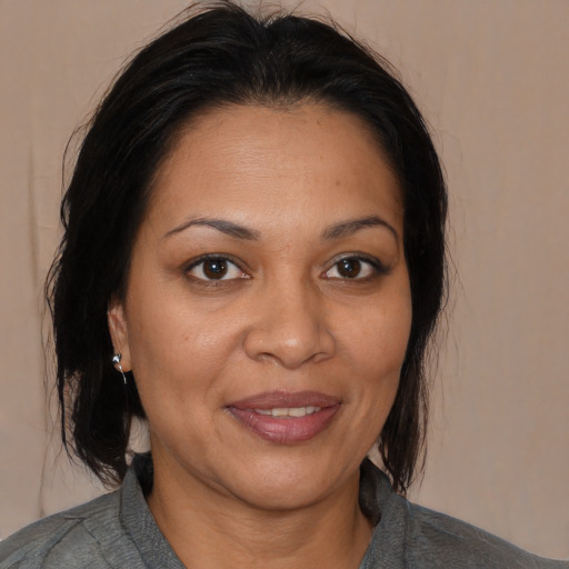 Joyful white adult female with medium  brown hair and brown eyes
