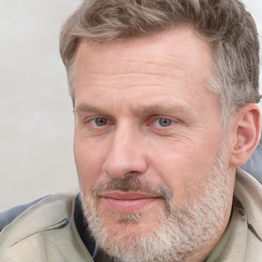 Joyful white adult male with short  brown hair and grey eyes