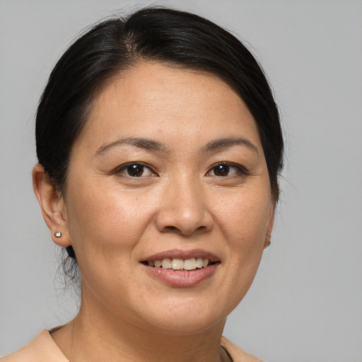 Joyful white adult female with medium  brown hair and brown eyes