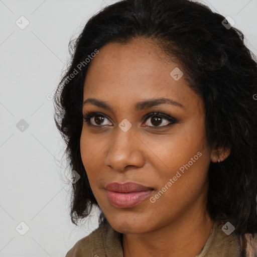 Joyful black young-adult female with long  brown hair and brown eyes