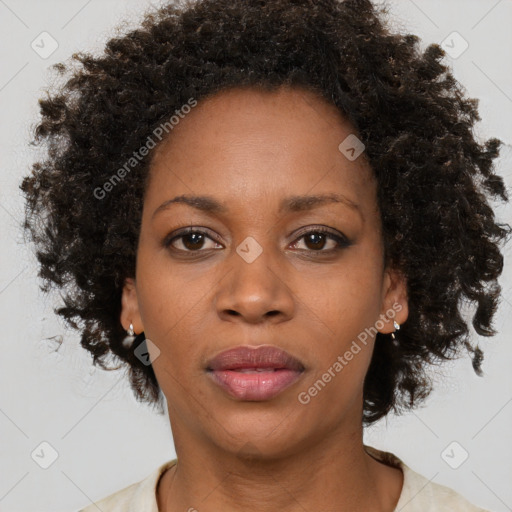 Joyful black adult female with medium  brown hair and brown eyes