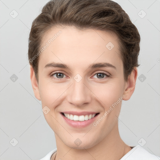 Joyful white young-adult female with short  brown hair and grey eyes