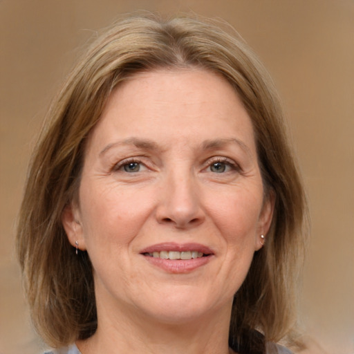 Joyful white adult female with medium  brown hair and grey eyes