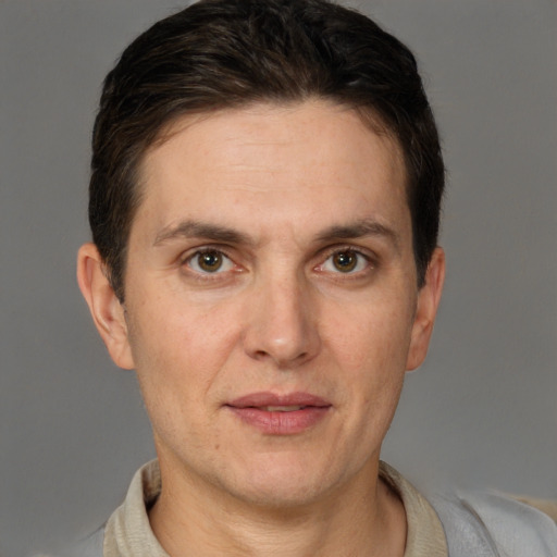 Joyful white adult male with short  brown hair and brown eyes