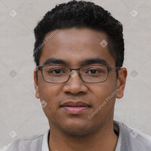 Joyful black young-adult male with short  black hair and brown eyes