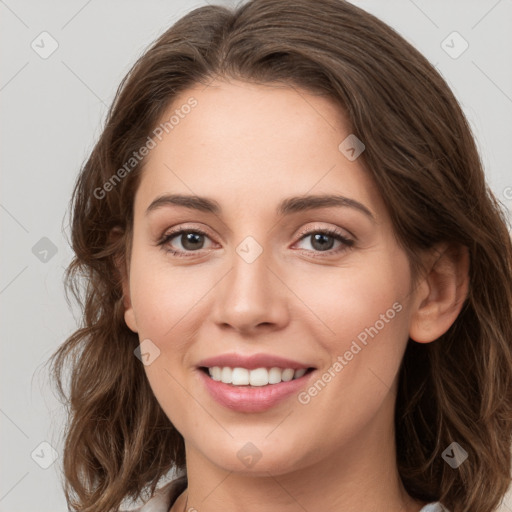 Joyful white young-adult female with long  brown hair and green eyes