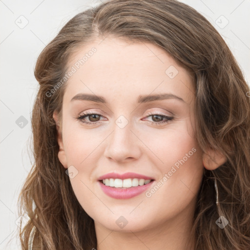 Joyful white young-adult female with long  brown hair and green eyes