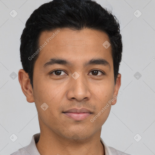 Joyful latino young-adult male with short  black hair and brown eyes