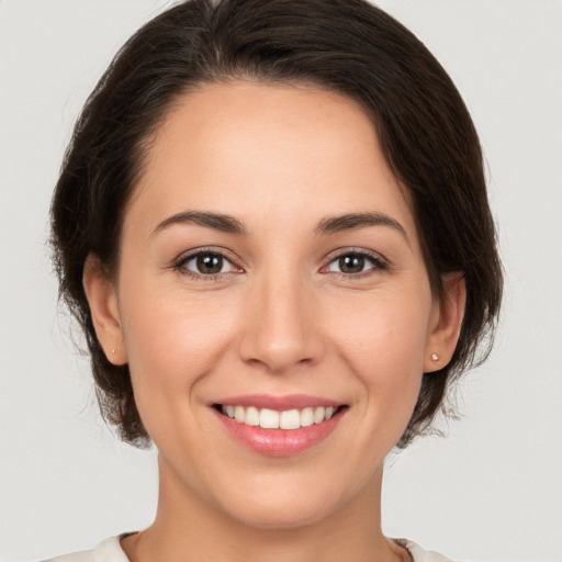 Joyful white young-adult female with medium  brown hair and brown eyes