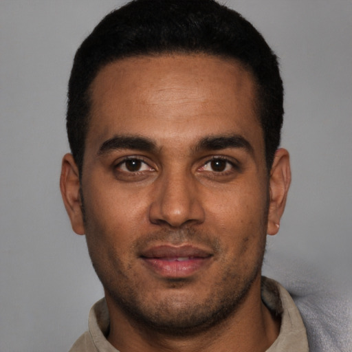 Joyful white young-adult male with short  black hair and brown eyes