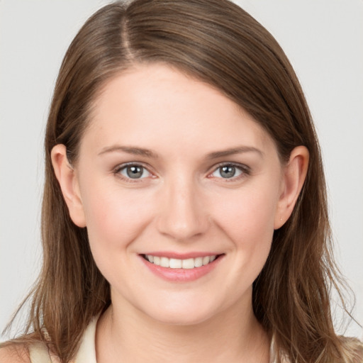 Joyful white young-adult female with long  brown hair and grey eyes