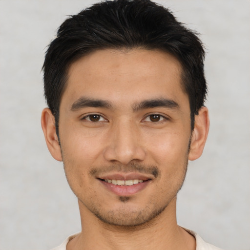 Joyful asian young-adult male with short  black hair and brown eyes