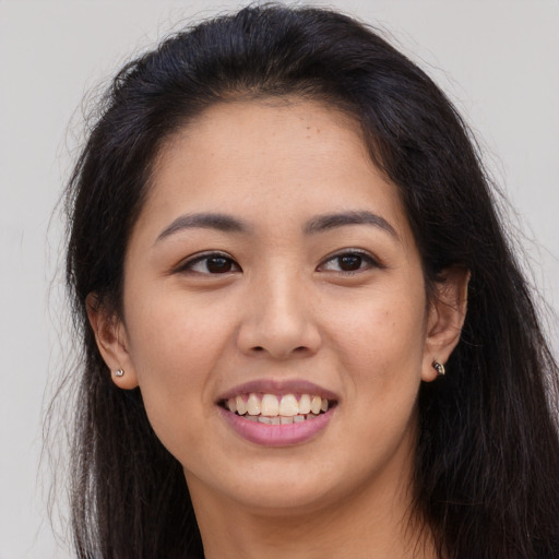 Joyful asian young-adult female with long  brown hair and brown eyes