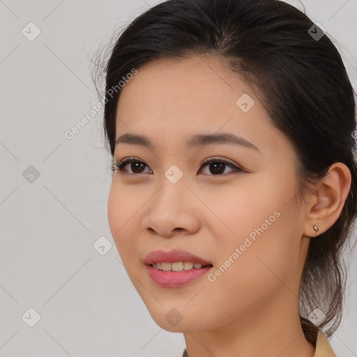 Joyful asian young-adult female with long  brown hair and brown eyes