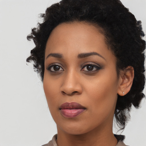 Joyful black young-adult female with medium  black hair and brown eyes