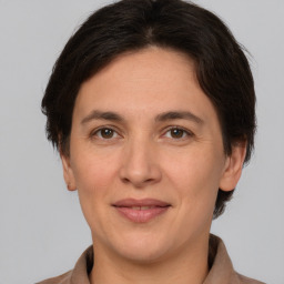 Joyful white adult female with short  brown hair and brown eyes