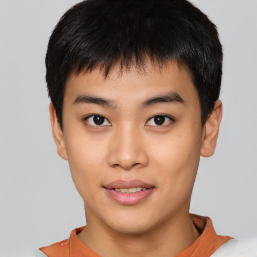 Joyful asian young-adult male with short  brown hair and brown eyes