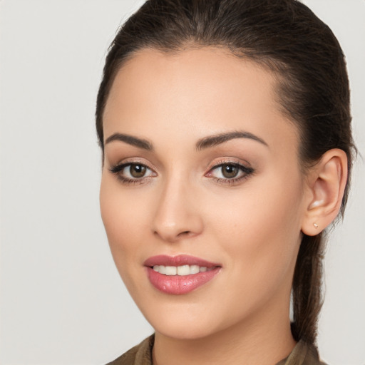 Joyful white young-adult female with long  brown hair and brown eyes