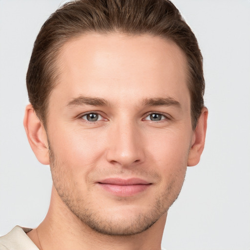 Joyful white young-adult male with short  brown hair and grey eyes