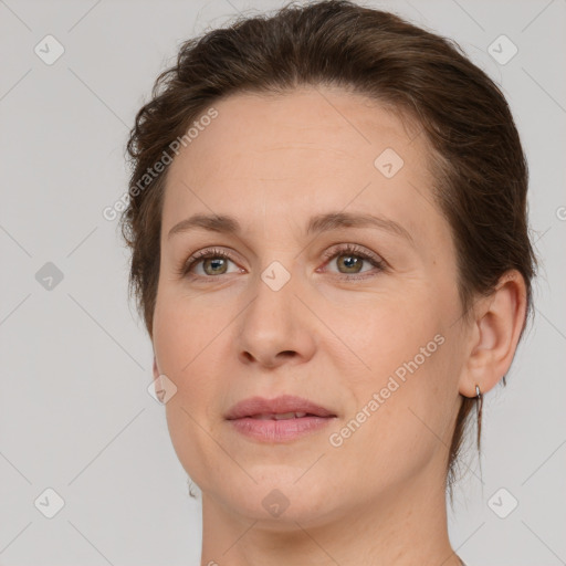 Joyful white adult female with medium  brown hair and grey eyes