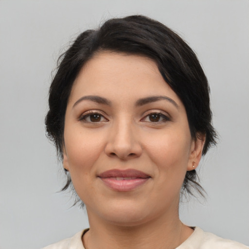 Joyful latino young-adult female with medium  black hair and brown eyes