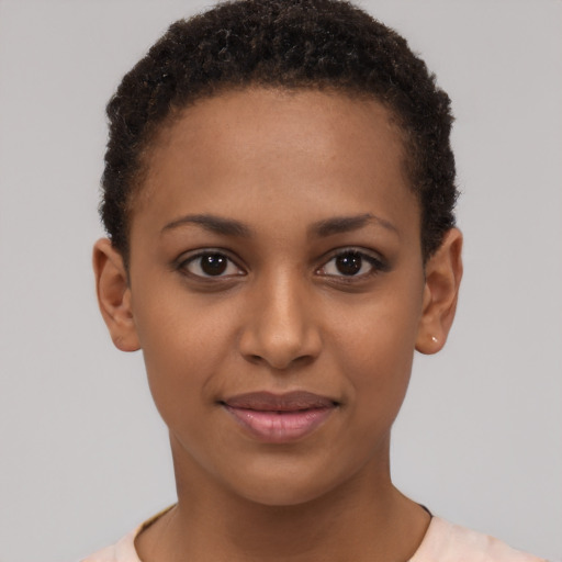Joyful black young-adult female with short  brown hair and brown eyes