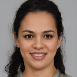 Joyful latino young-adult female with medium  brown hair and brown eyes