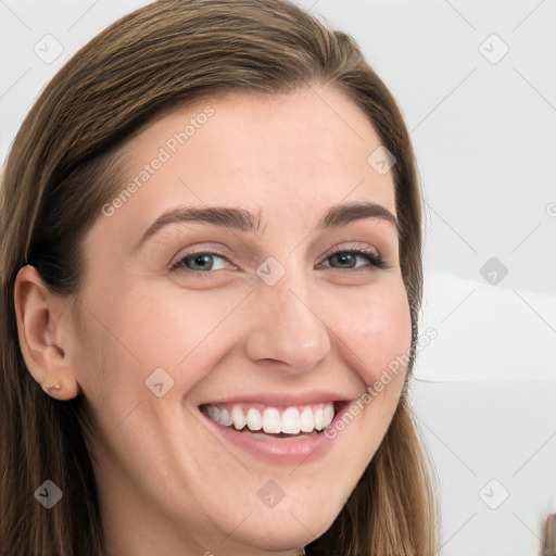 Joyful white young-adult female with long  brown hair and blue eyes