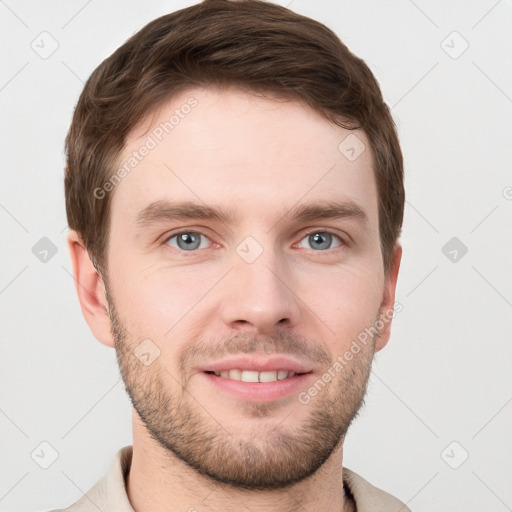 Joyful white young-adult male with short  brown hair and grey eyes