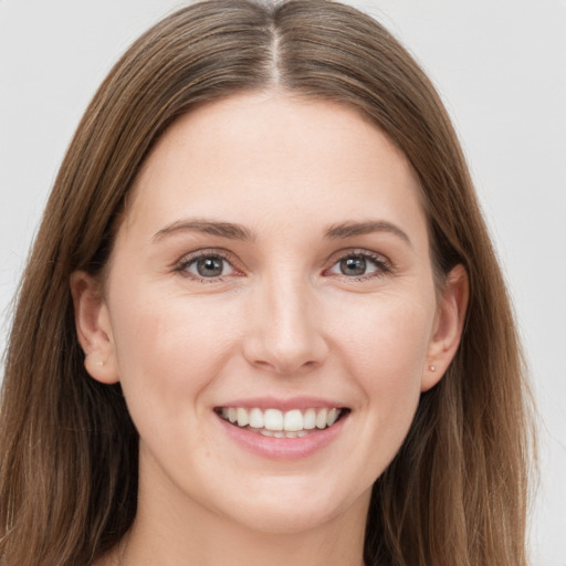 Joyful white young-adult female with long  brown hair and grey eyes