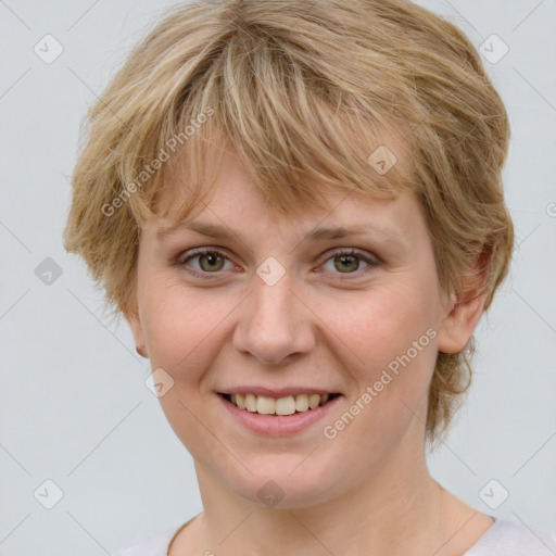 Joyful white young-adult female with medium  brown hair and blue eyes