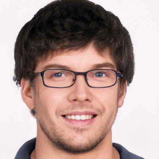 Joyful white young-adult male with short  brown hair and blue eyes